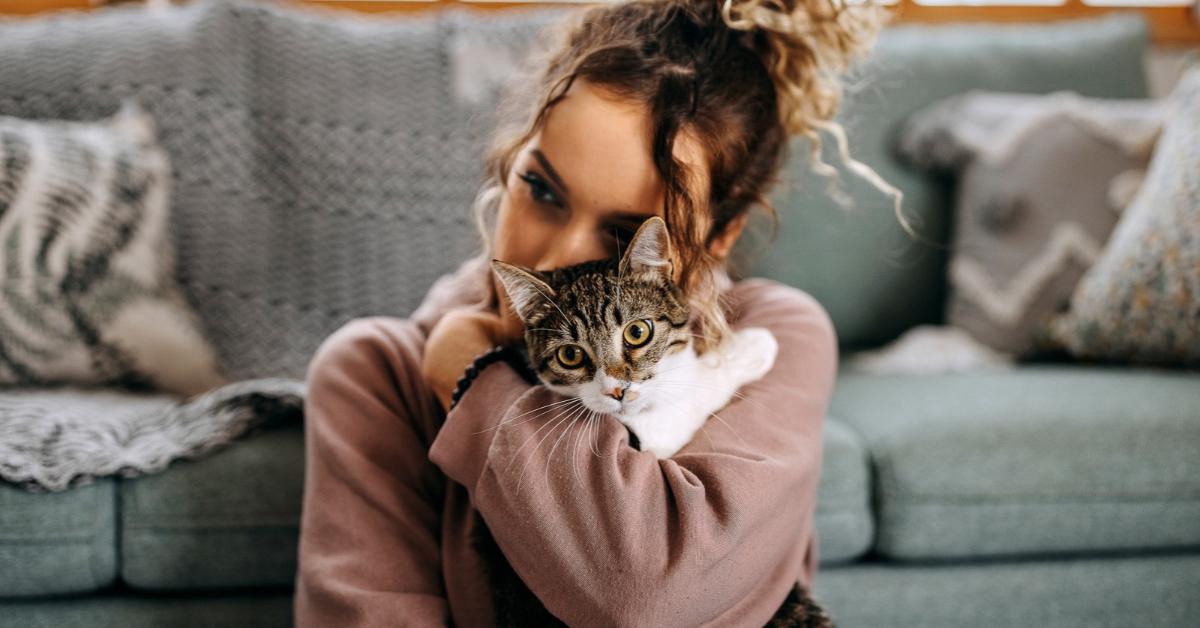Image of a lady hugging her cat